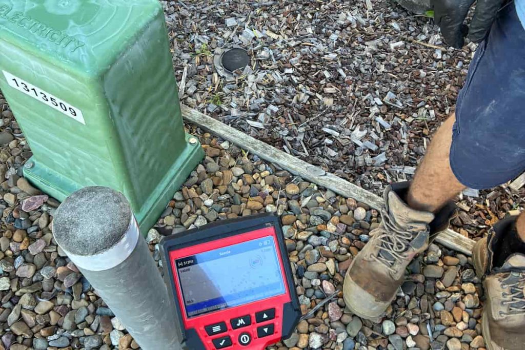 Coffison Plumbing technician using specialised equipment to detect a water leak near a residential service line.
