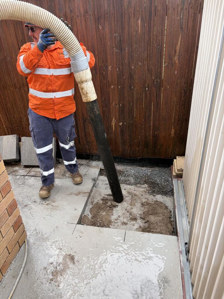 Hydro-vac excavation through a cut concrete opening in Redcliffe