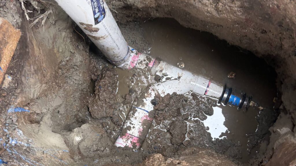 New PVC sewer junction installed in the excavated trench at a Redcliffe property