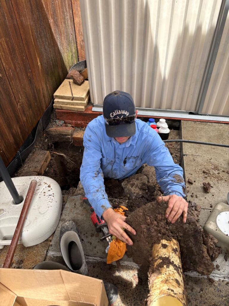 Coffison plumber removing root-filled sewer pipework in Redcliffe